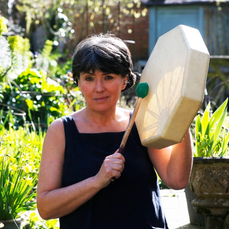 Emma Pruen with shamanic drum in the garden